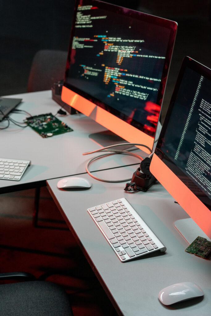Two computer monitors with coded data